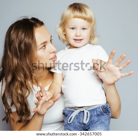 pretty real fashion mother with cute blond little daughter close up smiling happy