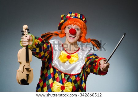 Clown in funny concept on dark background