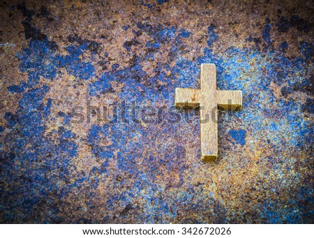 Image of wooden cross on rusty metal, old zinc background