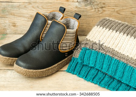 Kids boots on wooden table background, vintage style