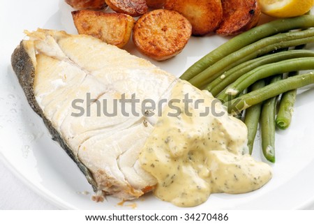 Freshly cooked halibut steak meal with bearnaise sauce
