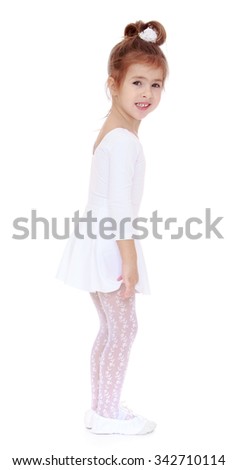 Cute little girl in a White sports leotard and white stockings stands sideways to the camera - Isolated on white background