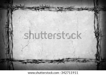 frame made of barbed wire on the brown background