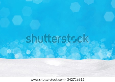 Snow on abstract blue bokeh background