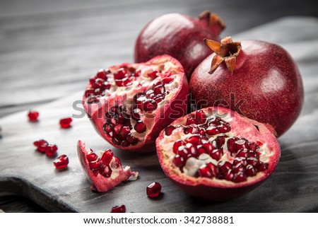 Red juice pomegranate on dark background Royalty-Free Stock Photo #342738881