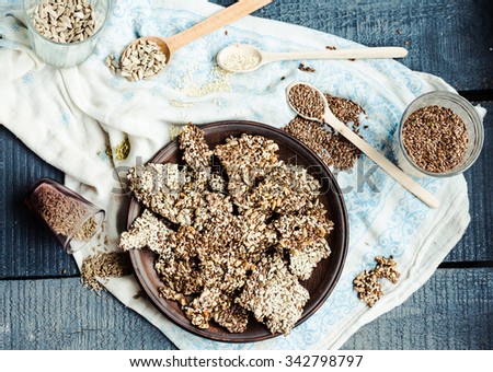 crackers from flax seed, sesame, sunflower and spices on a dark plate, healthy snack Royalty-Free Stock Photo #342798797