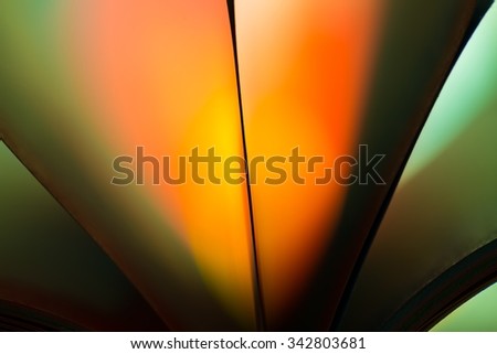 Colorful paper abstraction made with curved paper sheets and colorful lights.