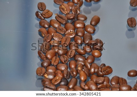 close up of roasted coffee beans on blurry background