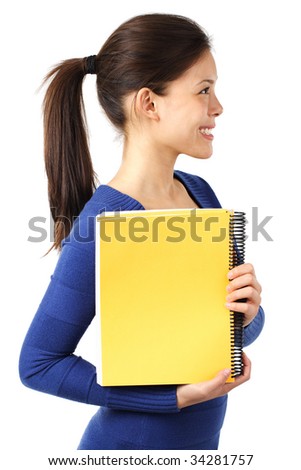 Smiling female university student showing blank yellow notebook. Isolated on white background