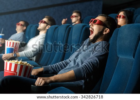 So realistic. Young man screaming as he is watching movie in his 3d glasses at the cinema 