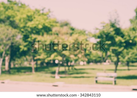 Abstract blurred big green park in city - defocus background / Vintage effect style