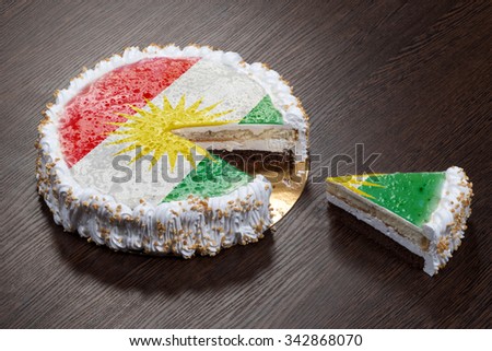 The symbol of war and separatism: a cake with a picture of the flag of Kurdistan is broken into pieces