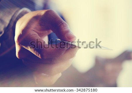 Male hand showing credit card.Vintage or pastel effect photo.