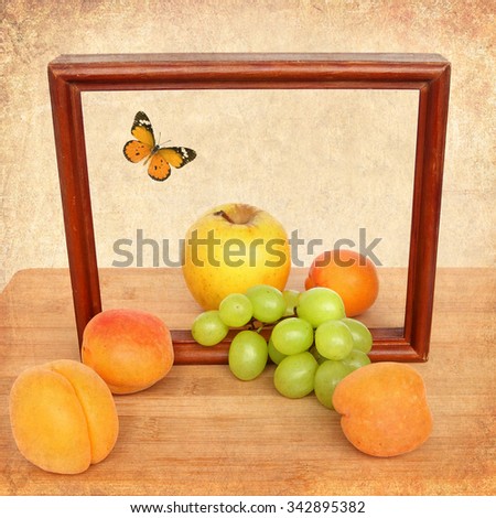 Old paper textured background with ripe sweet fruit wood decoration. Apricot, grapes and apple fruit with butterfly. Nature and food design . Art of healthy food 