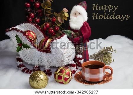 Home decor Santa and his sleigh on snow and tree decorations table setting accompanied by a warm cup of coffee