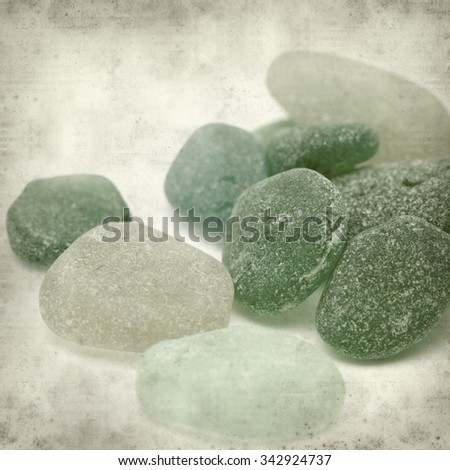 textured old paper background with sea glass pieces