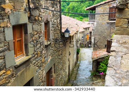 Old picturesque houses in mountains village.  Rupit i Pruit, Catalonia Royalty-Free Stock Photo #342933440