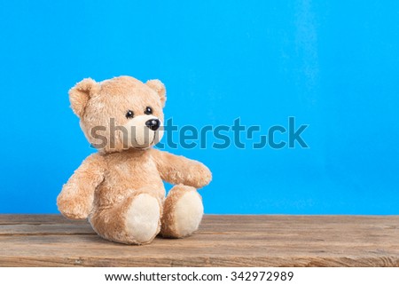Teddy Bear toy alone with blue background