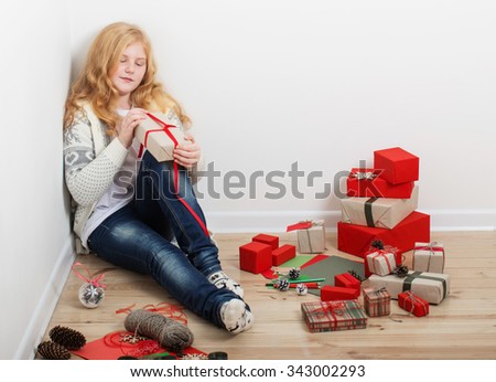 girl wrapping Christmas gifts