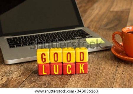 Good Luck written on a wooden cube in a office desk Royalty-Free Stock Photo #343036160