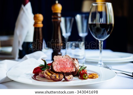 Beef steak with grilled vegetables served on white plate Royalty-Free Stock Photo #343041698