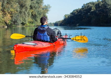 The man is kayaking on the river. Royalty-Free Stock Photo #343084052