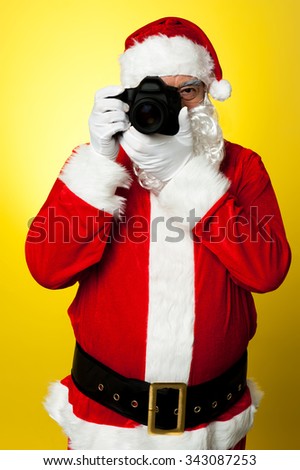 Man in Santa dress capturing picture