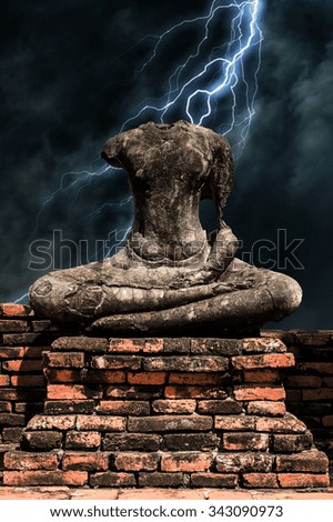 Old headless broken buddha statue lightning at Ayutthaya Thailand