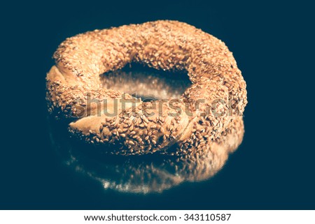 Turkish bread with sesame seeds on a table with reflective surface. Selective focus. Shallow depth of field. Selective Focus. Toned.