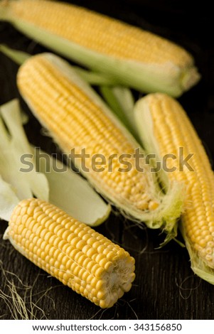Organic sweet corn on wooden table. Selective focus.