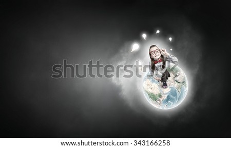 Wideangle picture of funny schoolgirl with paper plane. Elements of this image are furnished by NASA