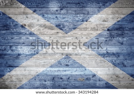 A vignetted background image of the flag of Scotland onto wooden boards of a wall or floor.