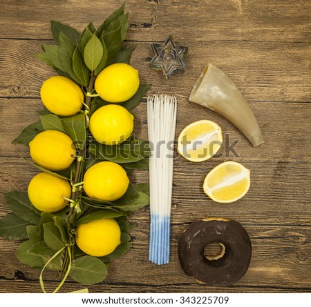  Branch lemons  donuts candles  crown of thorns and goat horn. Symbols of the great holiday of Hanukkah. On wooden background
