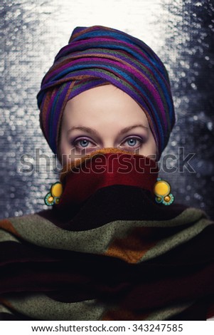 Beautiful young woman with scarf and kerchief.Color effects and custom white balance are used on this picture.