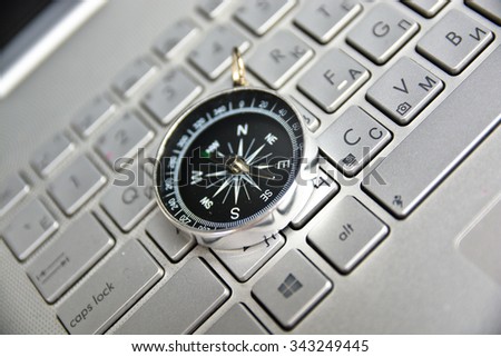 Navigation on the Internet! Photo of magnetic compass on computer keyboard.