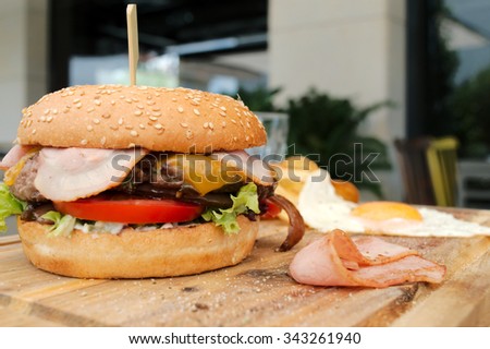 Hamburger with bacon, egg and potatoes