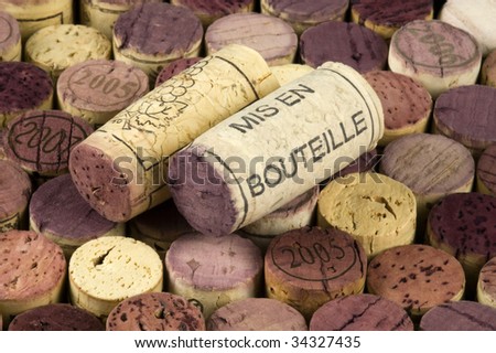 Mis en bouteille printed cork on a background of wine stoppers.