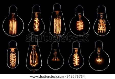Glowing vintage light bulbs set. Black background Royalty-Free Stock Photo #343276754