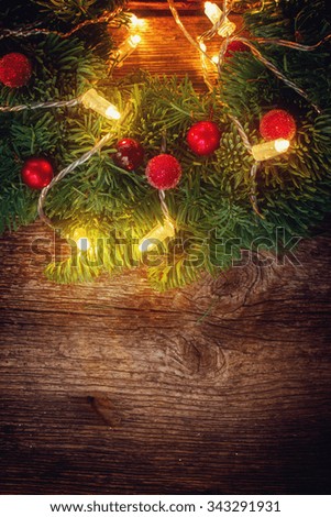 christmas wreath with lights on wooden table, retro toned