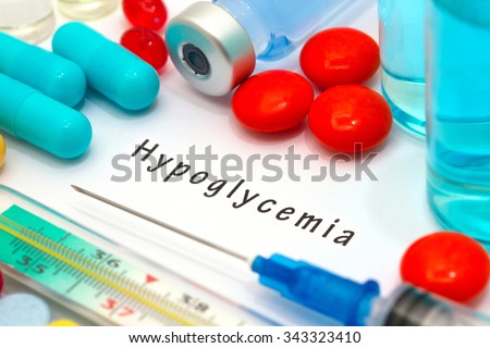 Hypoglycemia - diagnosis written on a white piece of paper. Syringe and vaccine with drugs Royalty-Free Stock Photo #343323410