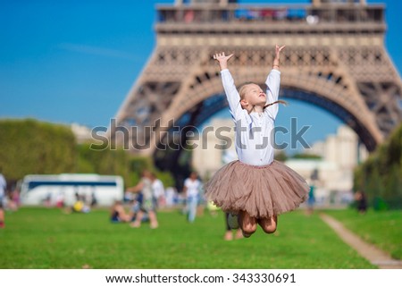 Adorable little girl in Paris background the Eiffel tower during summer vacation