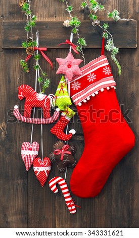 Christmas decoration stocking and handmade toys over rustic wooden background. Festive ornaments