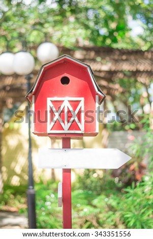 Bird house with empty arrow sign