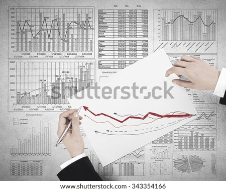 Businessman hands writing with pen infographs on paper