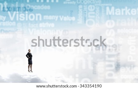 Young confident businesswoman with hands on waist