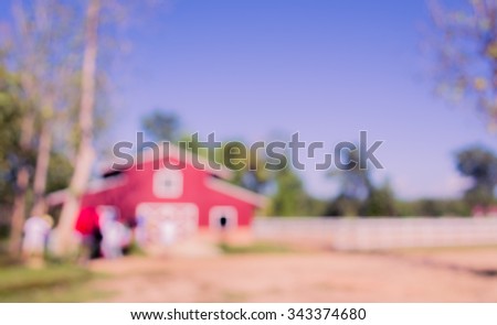 image of blur barn on sunny day  for background usage . (vintage tone)