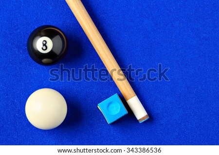 Billiard balls, cue and chalk on a blue pool table. Viewed from above. Horizontal image. Royalty-Free Stock Photo #343386536