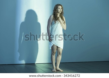 Battery victim in underwear alone in empty room Royalty-Free Stock Photo #343416272