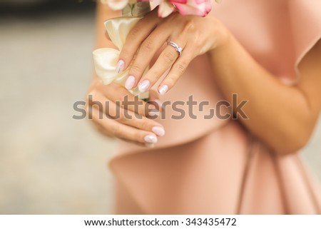 Bride with flower bouquet and engagement ring Royalty-Free Stock Photo #343435472