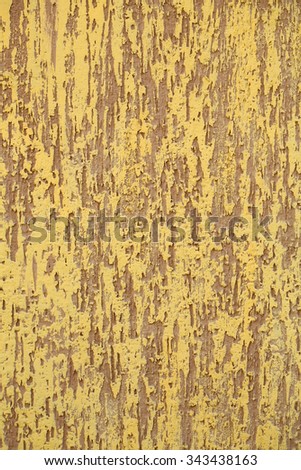 Photo closeup of warm plastered brown yellow painted colored wall rough textured decorative stucco facade interior on background, vertical picture 
